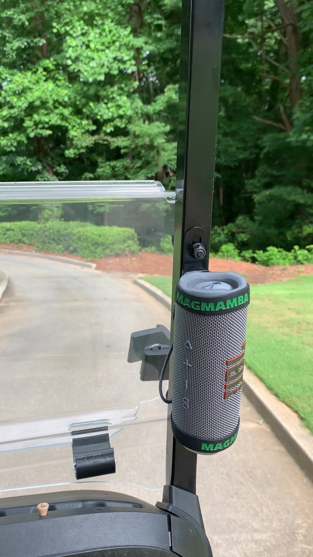 MagMamba Sound magnetic Bluetooth speaker holder securing a portable speaker to a golf cart upright on the golf course